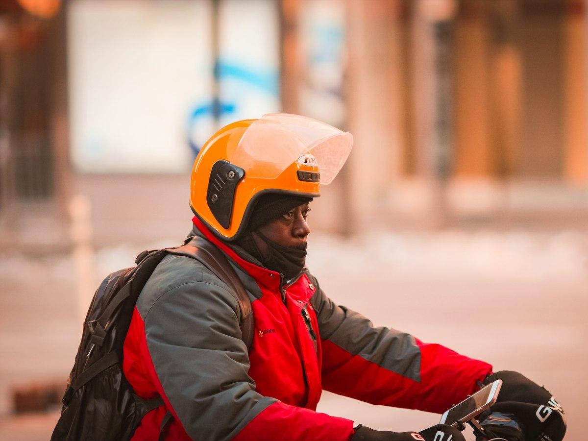 Delivery rider in a helmet riding through the city