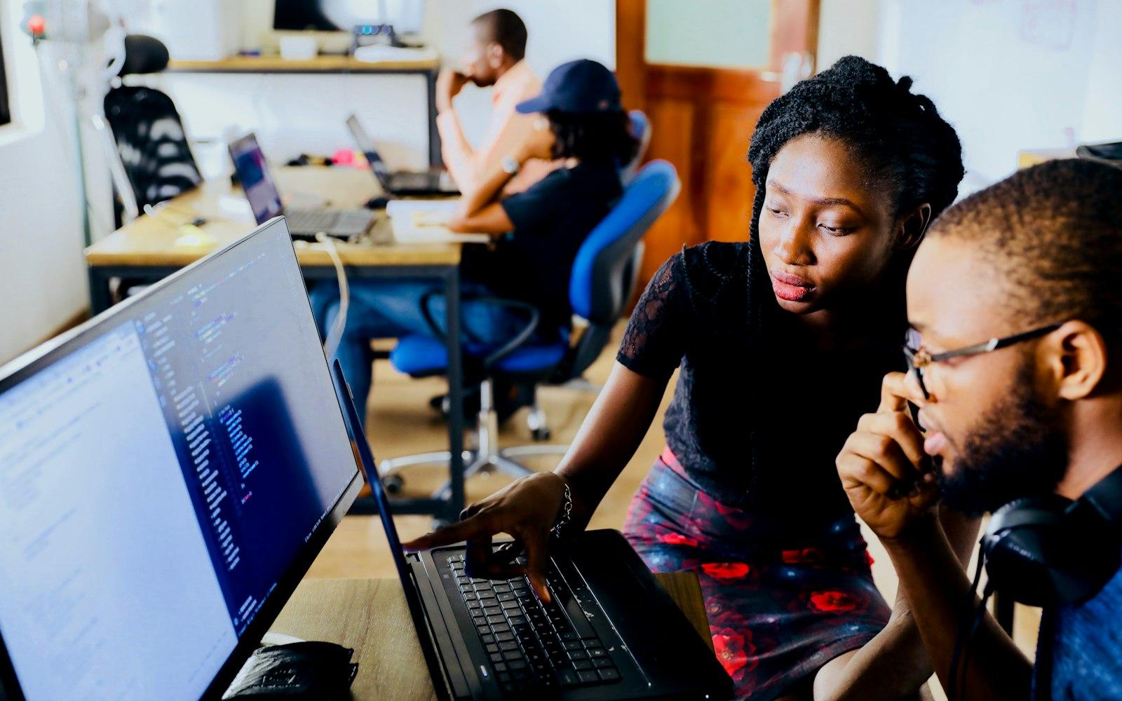 Two developers working together at their computers
